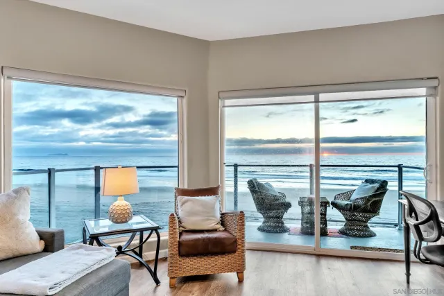 a living room with furniture and floor to ceiling window