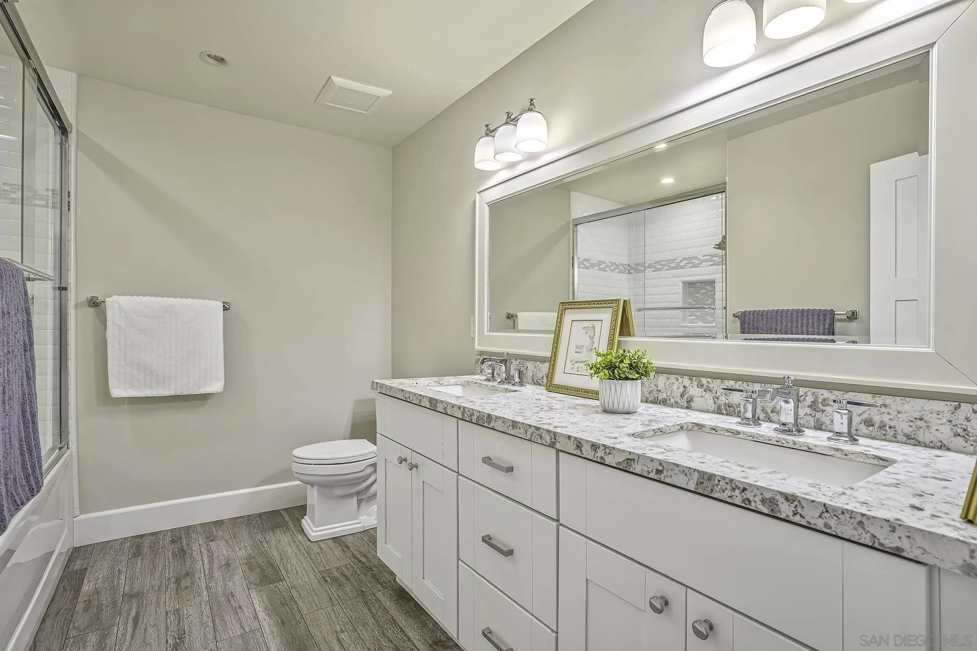 2826 Palomino Circle La Jolla, CA 92037 - Photo 20 of 34 a bathroom with a granite countertop sink a toilet and a mirror