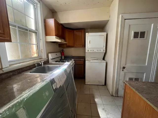 a kitchen with a sink stove and a refrigerator