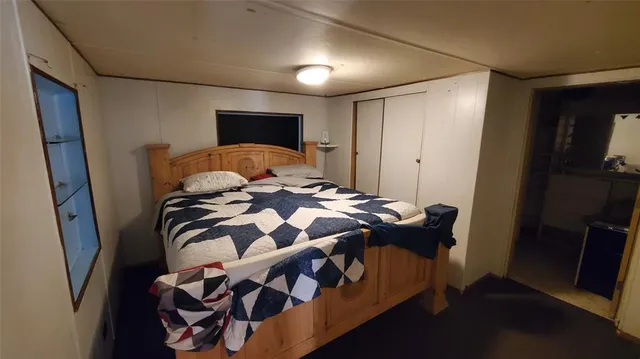 a bedroom with a bed and a mirror