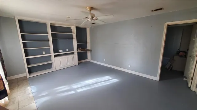 a view of an empty room with empty shelves