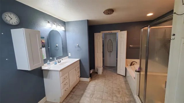 a bathroom with a double vanity sink mirror and shower