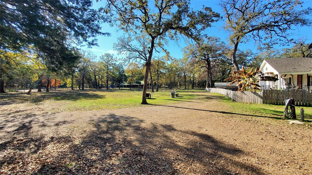 310 County Road 2406 Tool, TX 75143 - Photo 5 of 26 a view of a park with swings and a large tree