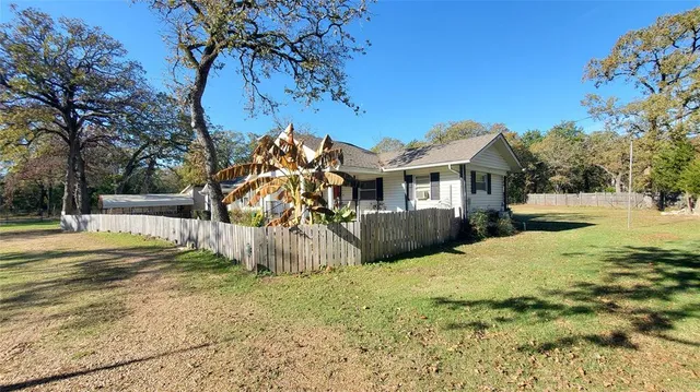 a view of a house with a yard covered with snow