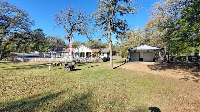 a view of a house with pool and sitting area