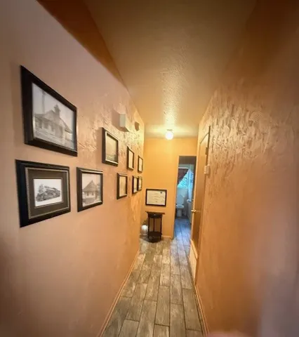 a view of a hallway with paintings on the wall