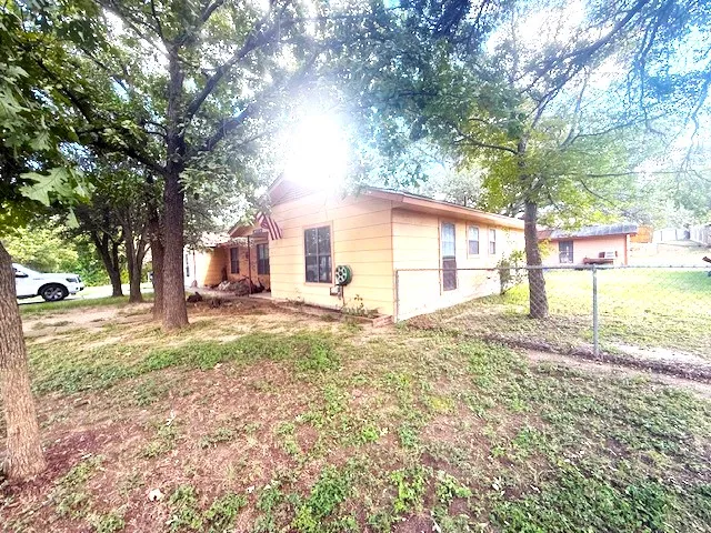 a view of a yard with a tree