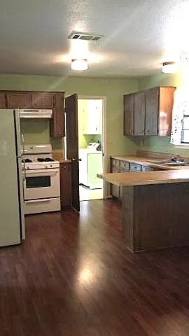 a kitchen with a stove and a refrigerator