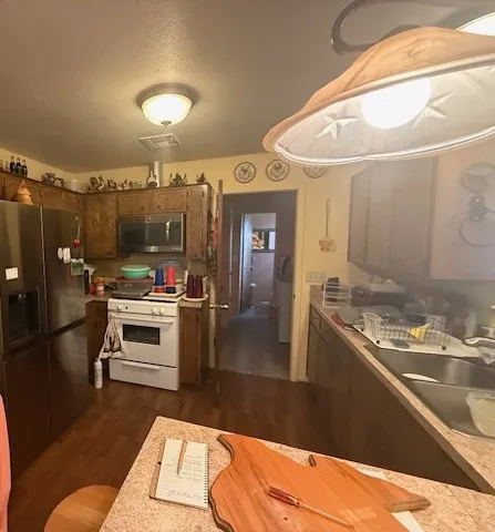 a kitchen with a stove and a refrigerator