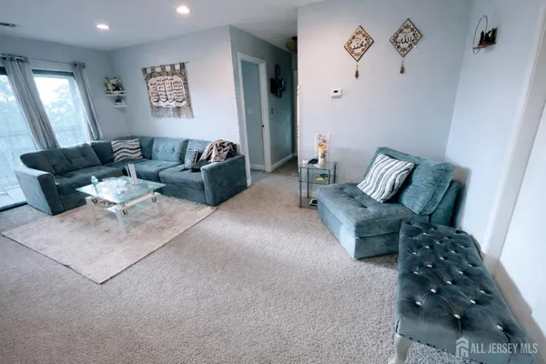 a living room with furniture and painting on the wall