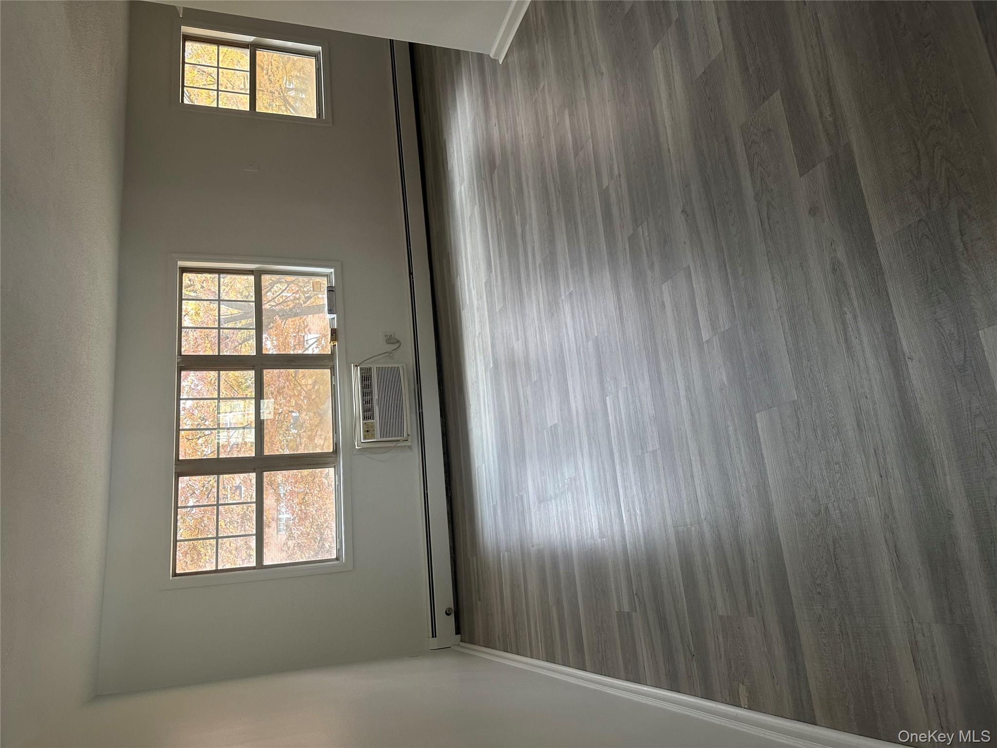 603 Barclay Manor, Unit 6C Newburgh, NY 12550 - Photo 2 of 7 wooden floor in an empty room with a window
