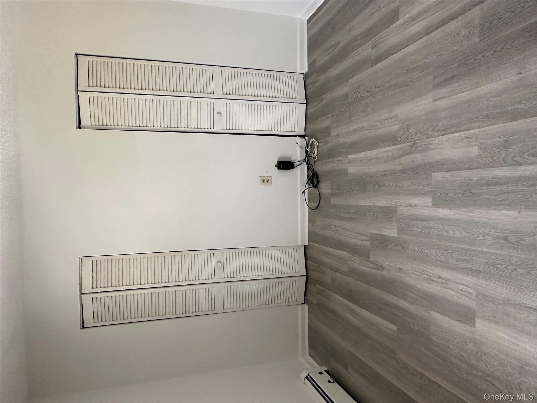 603 Barclay Manor, Unit 6C Newburgh, NY 12550 - Photo 5 of 7 a view of a room with wooden floor and white walls