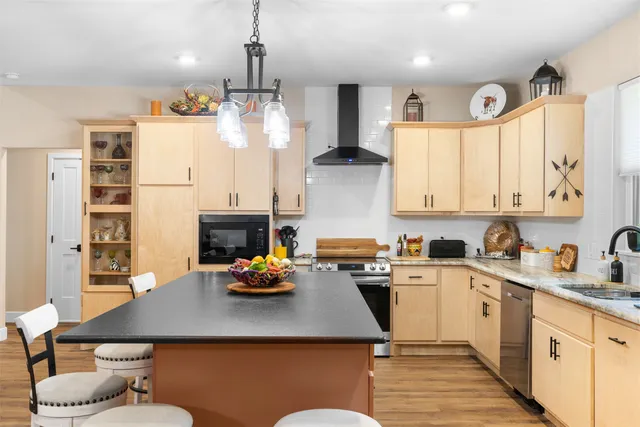 a kitchen with a sink appliances and cabinets