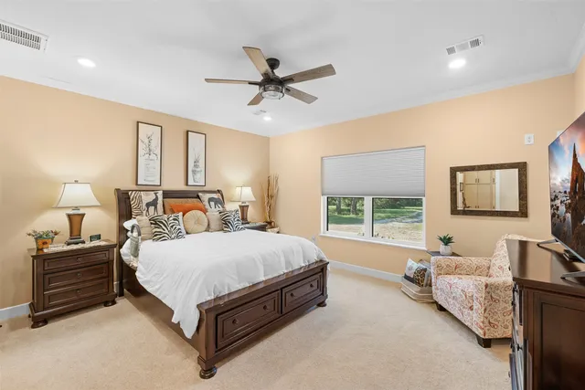 a bedroom with a bed couch and window