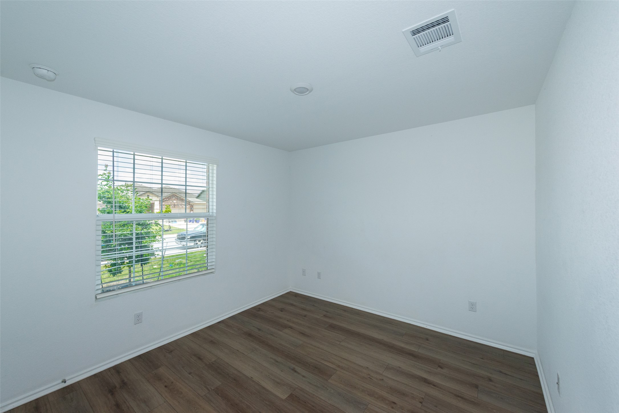 147 Otter Road Kyle, TX 78640 - Photo 4 of 34 2nd full bedroom facing front of the property, large open windows and natural light. All windows have blinds and screens they are just up for the photos