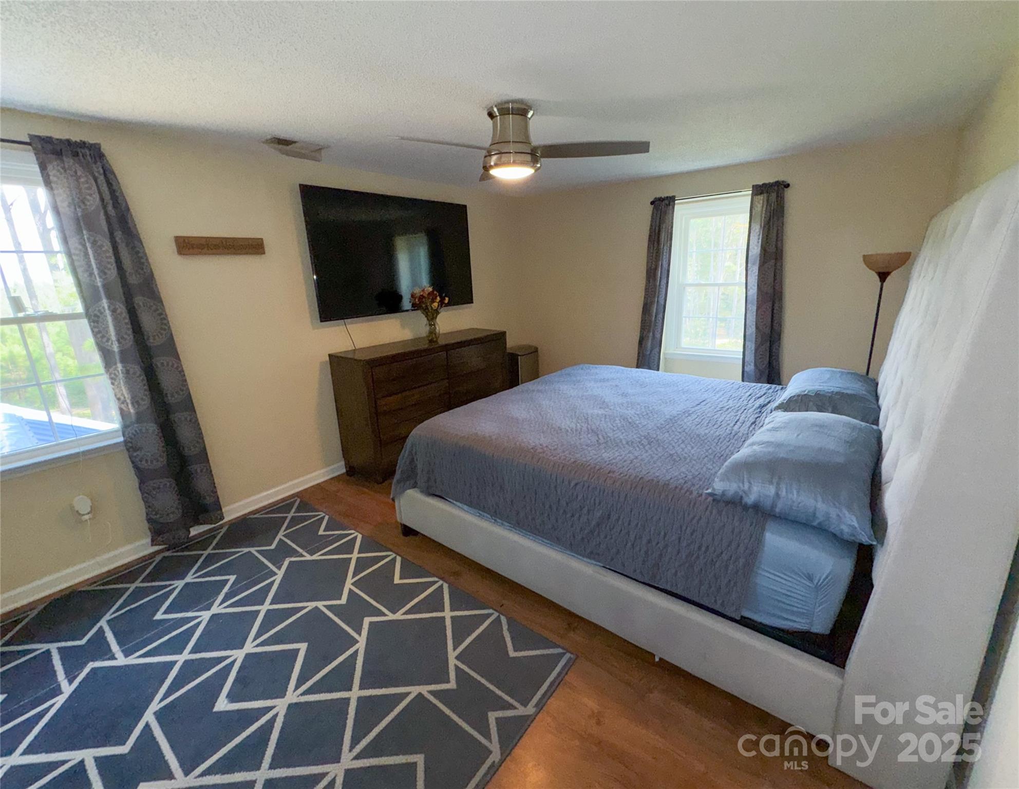 368 Gaddy Farm Road Mount Gilead, NC 27306 - Photo 14 of 25 a bedroom with a bed and a flat screen tv