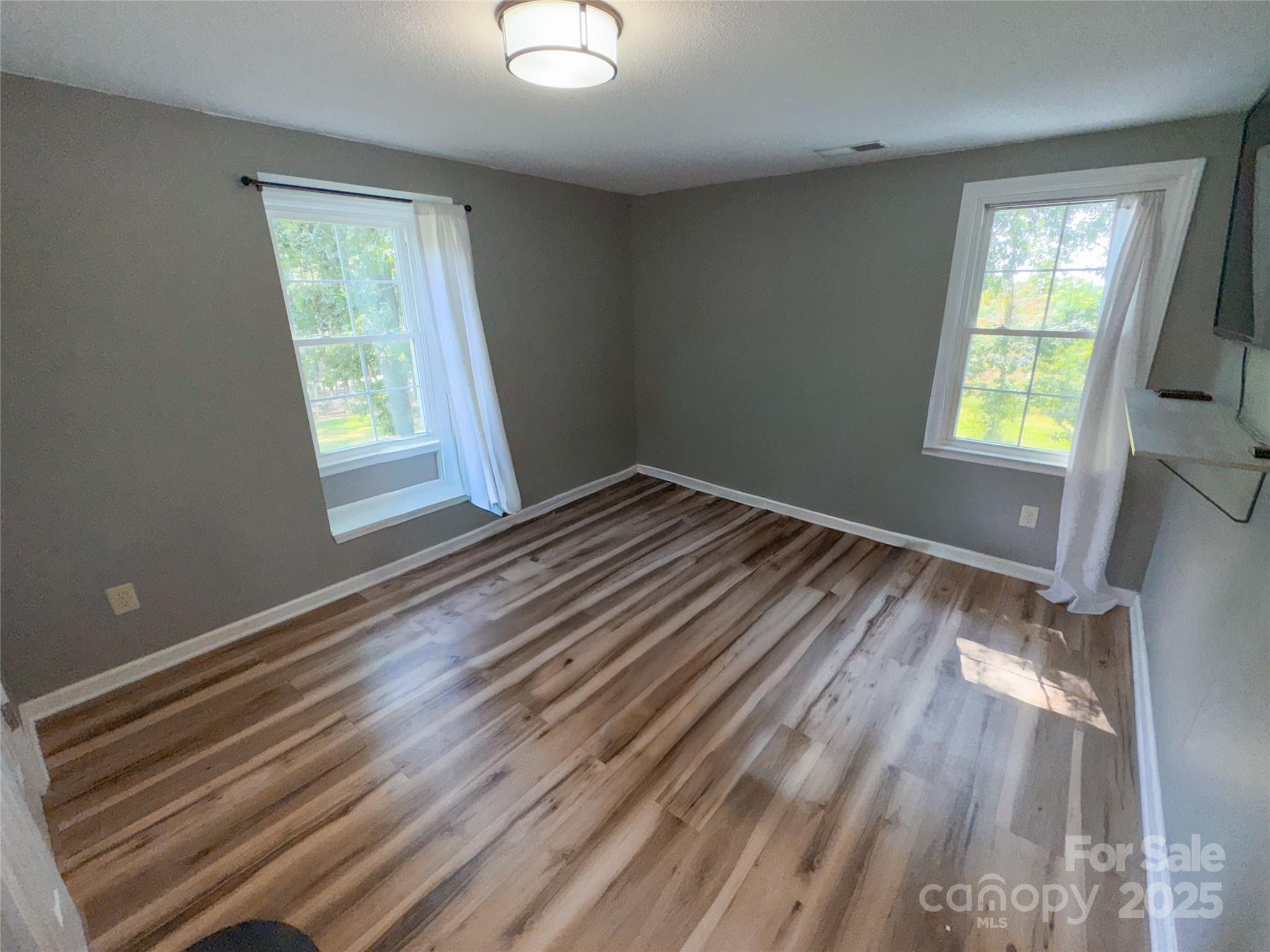 368 Gaddy Farm Road Mount Gilead, NC 27306 - Photo 17 of 25 a view of room with window and hardwood floor