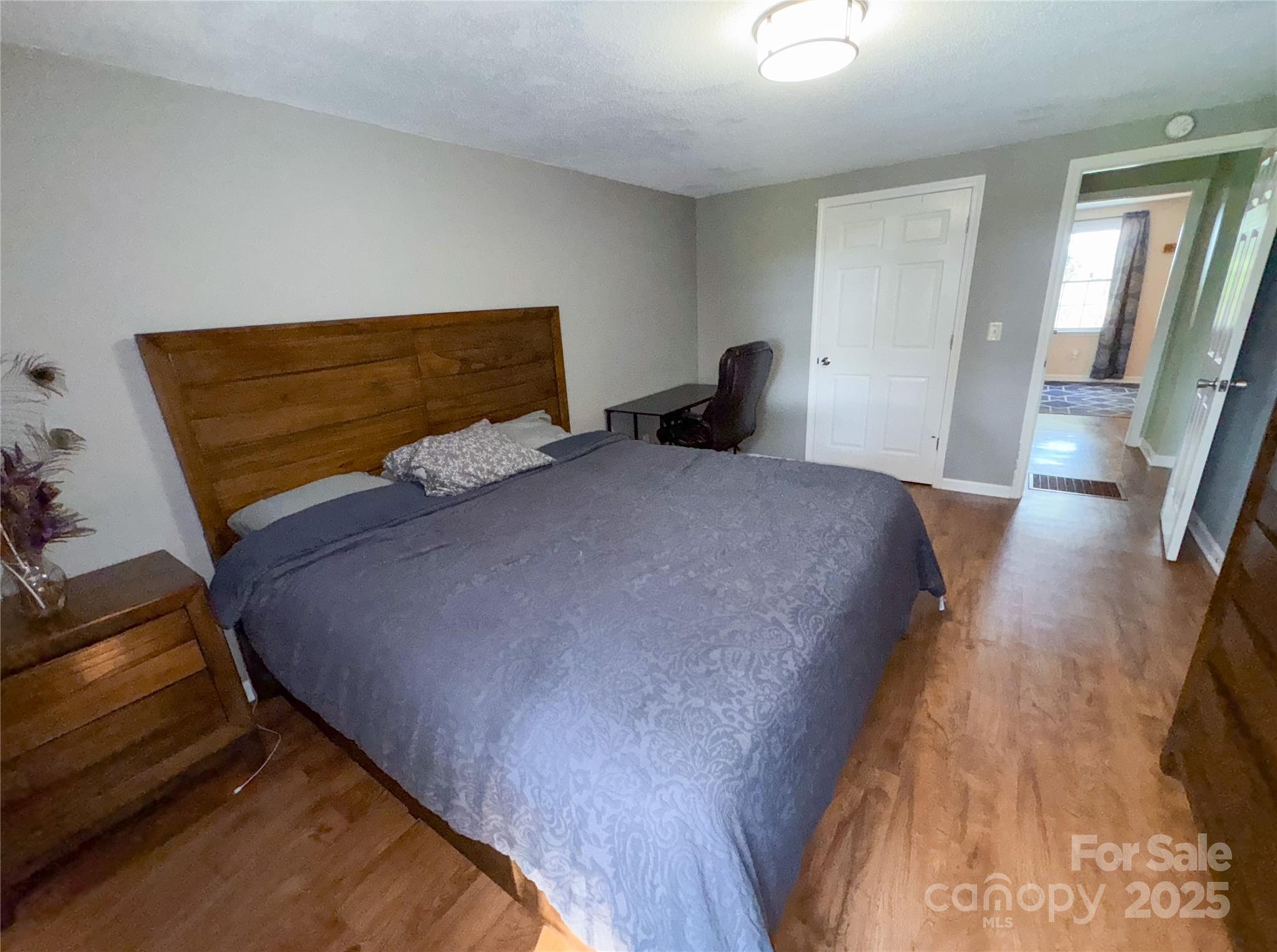 368 Gaddy Farm Road Mount Gilead, NC 27306 - Photo 19 of 25 a bedroom with a bed and wooden floor