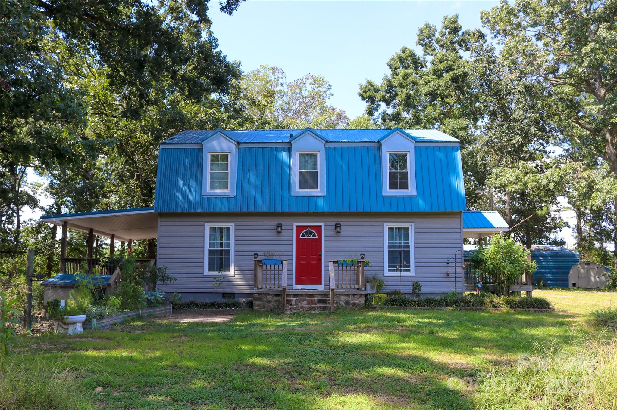 368 Gaddy Farm Road Mount Gilead, NC 27306 - Photo 2 of 25 a view of a house with a backyard