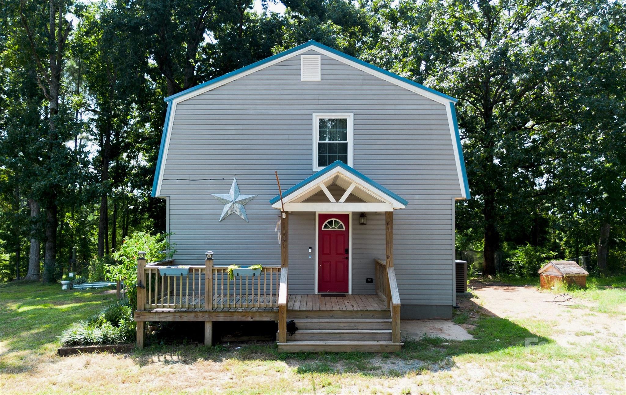 368 Gaddy Farm Road Mount Gilead, NC 27306 - Photo 22 of 25 a front view of a house with a garden and trees