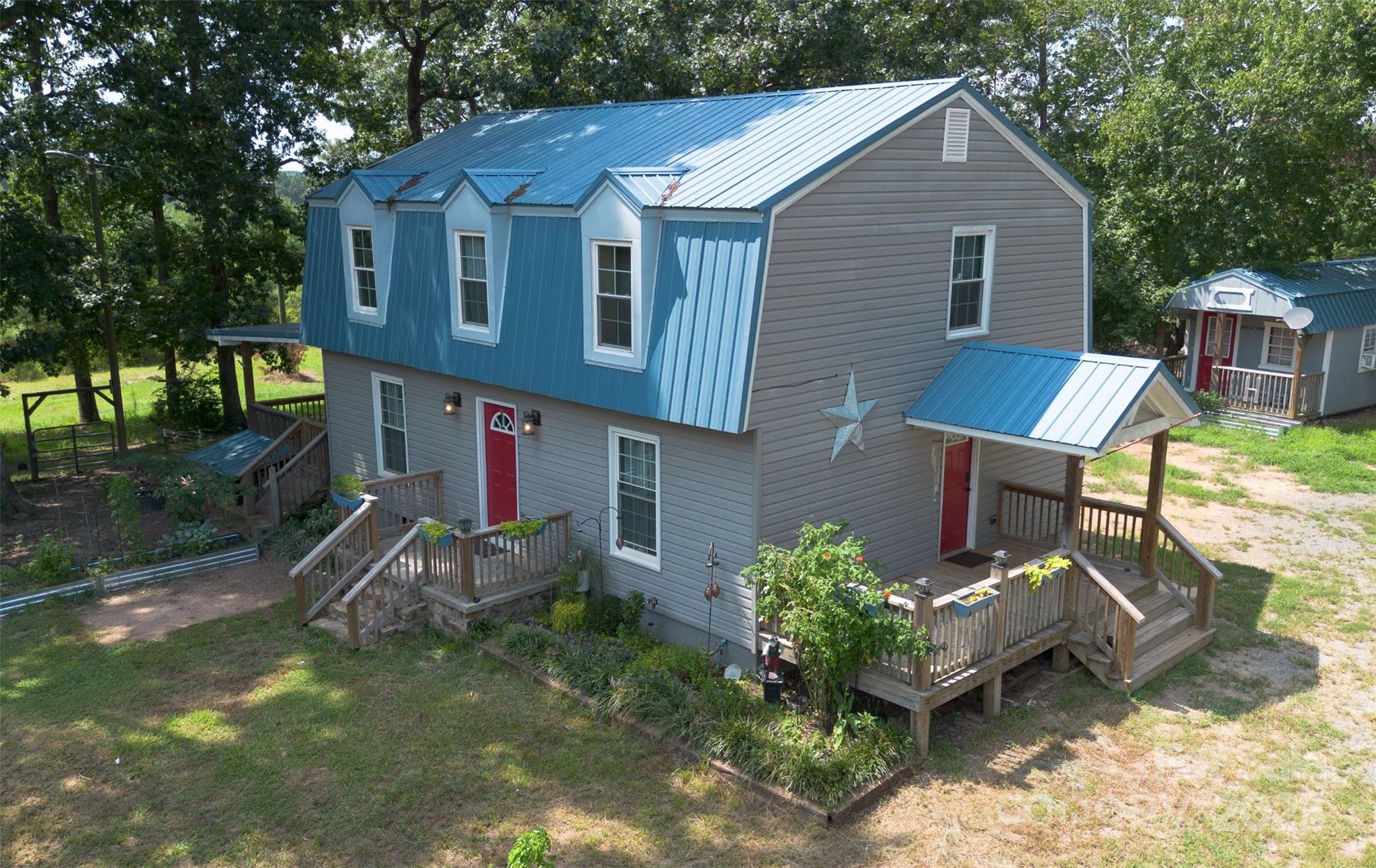 368 Gaddy Farm Road Mount Gilead, NC 27306 - Photo 23 of 25 a front view of a house with garden