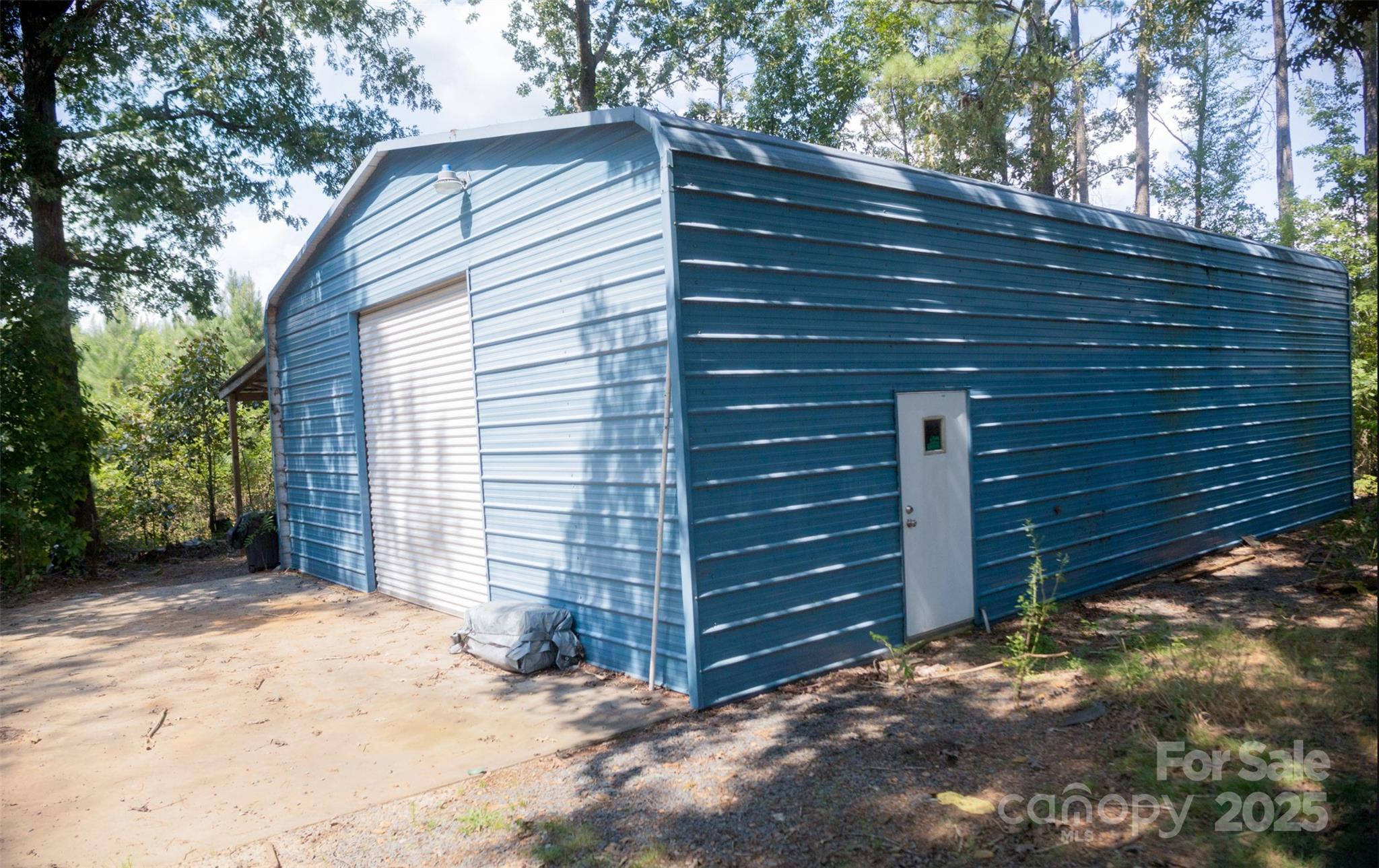 368 Gaddy Farm Road Mount Gilead, NC 27306 - Photo 24 of 25 a view of wooden house and a yard