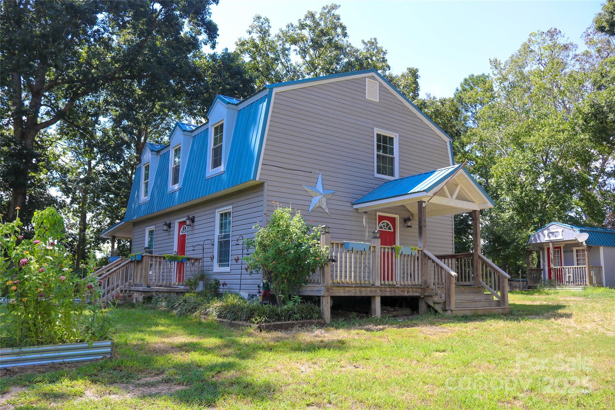 368 Gaddy Farm Road Mount Gilead, NC 27306 - Photo 4 of 25 a view of a house with a yard and sitting area