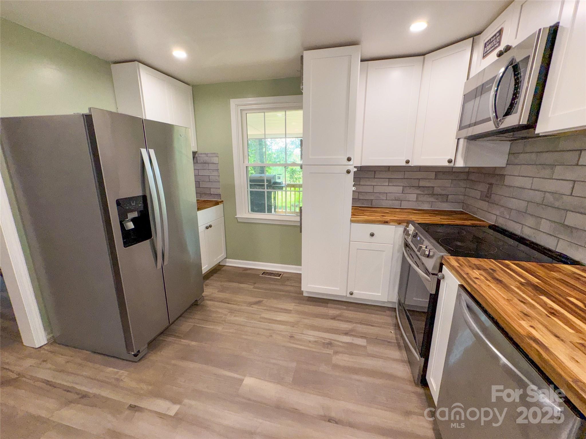 368 Gaddy Farm Road Mount Gilead, NC 27306 - Photo 7 of 25 a kitchen with stainless steel appliances granite countertop a refrigerator and a sink