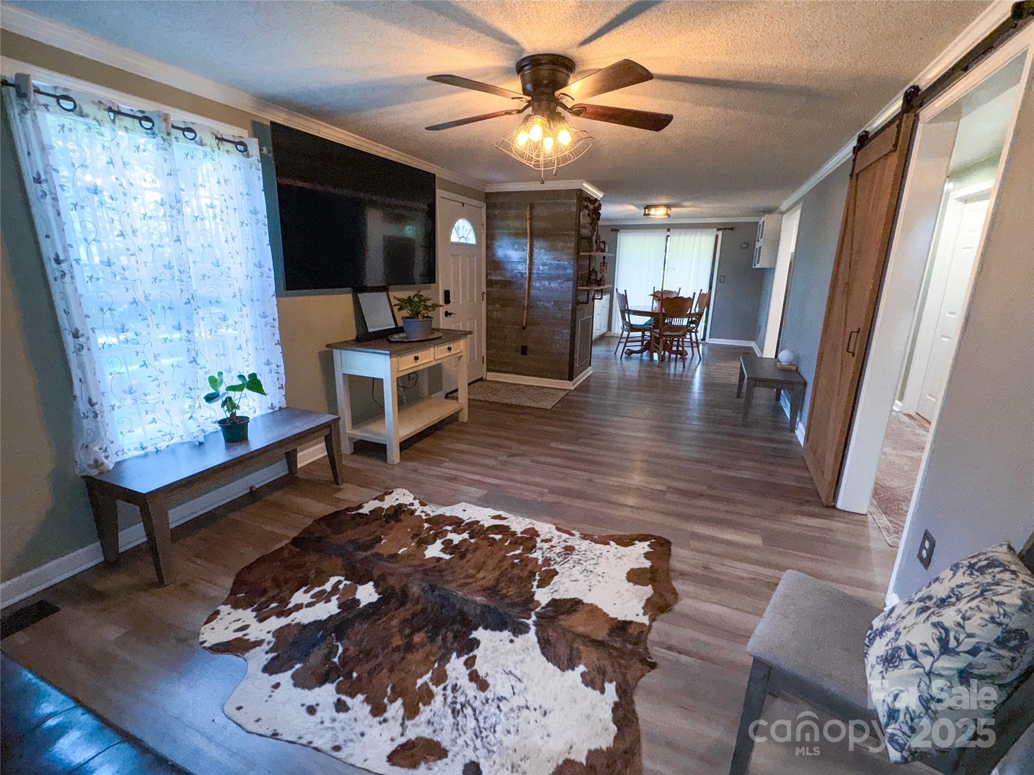 368 Gaddy Farm Road Mount Gilead, NC 27306 - Photo 8 of 25 a living room with furniture and a flat screen tv