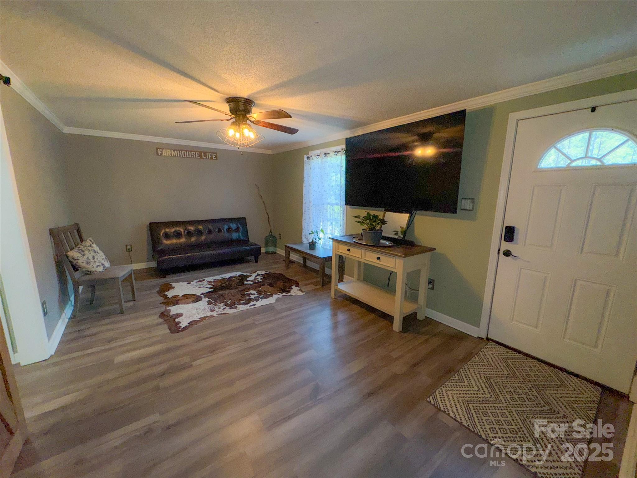368 Gaddy Farm Road Mount Gilead, NC 27306 - Photo 9 of 25 a living room with furniture and a flat screen tv