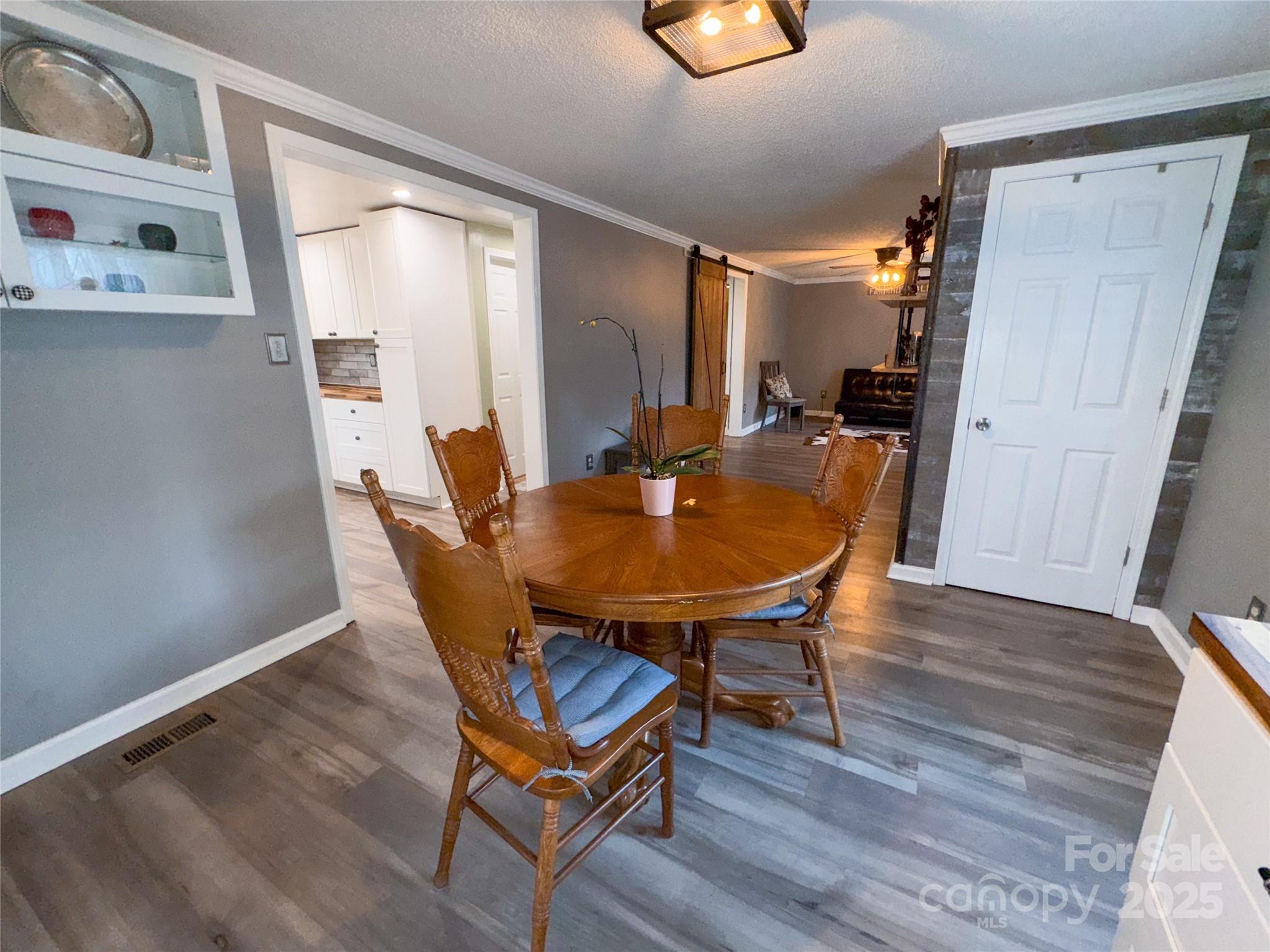 368 Gaddy Farm Road Mount Gilead, NC 27306 - Photo 10 of 25 a dining room with furniture and wooden floor