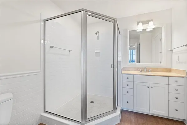 a bathroom with a shower sink and mirror