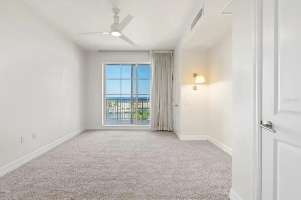 an empty room with windows and closet