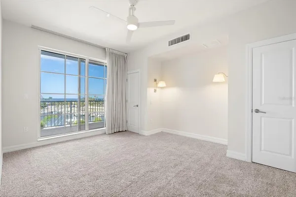an empty room with windows and closet