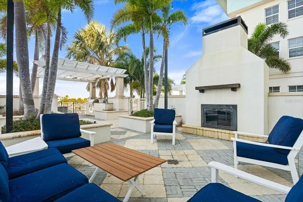 a outdoor space with patio the couches and a fireplace