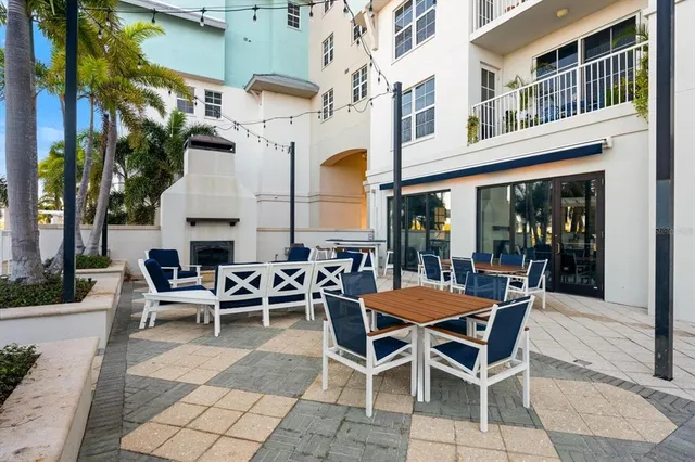 a view of a building with dining table and chairs