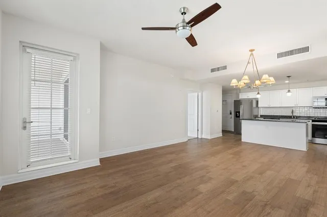 a view of a kitchen with an empty space and a ceiling fan