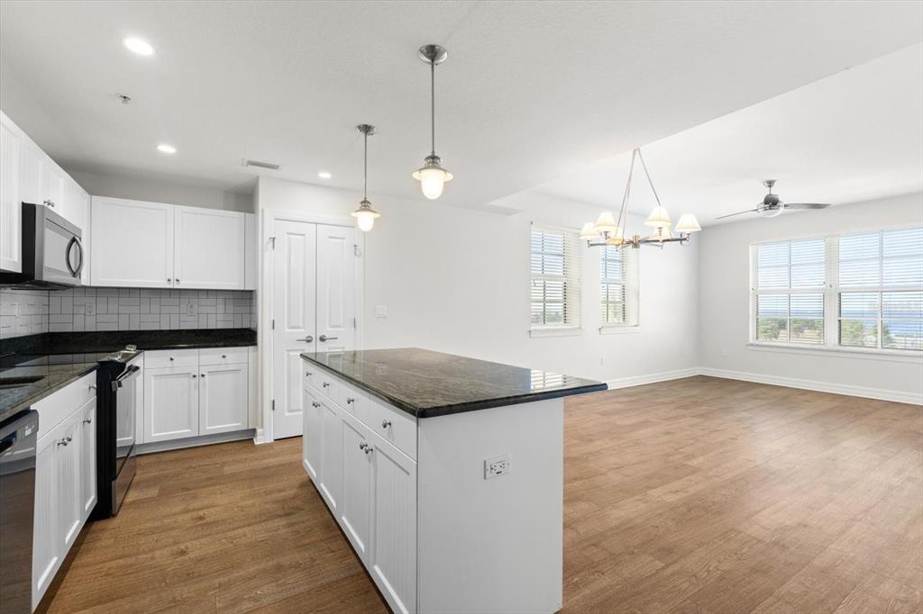 536 Bahia Beach Boulevard, Unit 222B Ruskin, FL 33570 - Photo 8 of 31 a kitchen with granite countertop counter space a sink appliances and cabinets