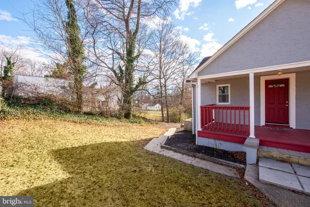 a view of a yard with wooden fence