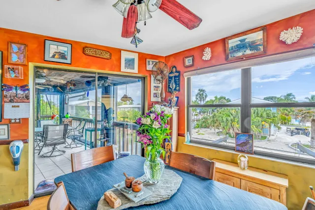 a living room with fireplace furniture and a large window