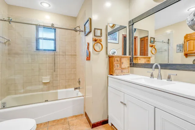 a bedroom with furniture and a large window