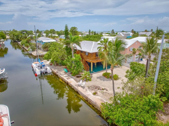 an aerial view of a house with a swimming pool patio and outdoor seating