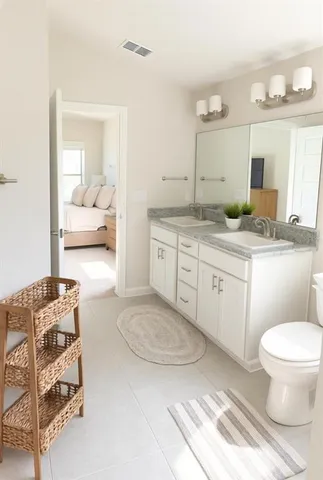a spacious bathroom with a granite countertop sink and a mirror