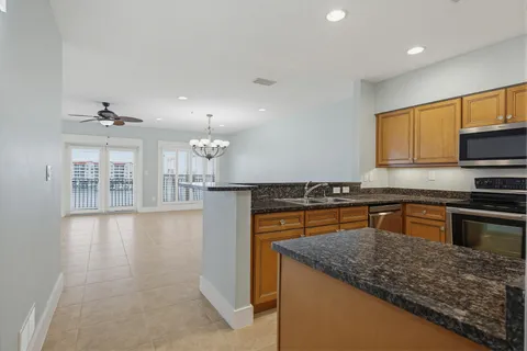 a kitchen that has a sink and a large mirror