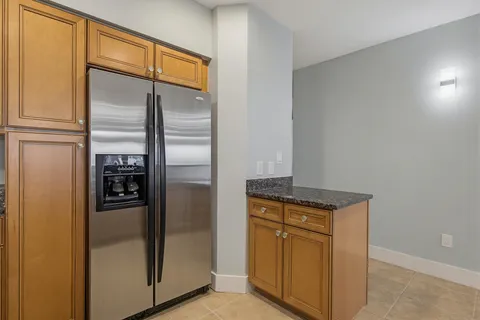 a view of kitchen with refrigerator and window