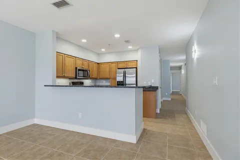 a view of a hallway view with wooden floor and staircase