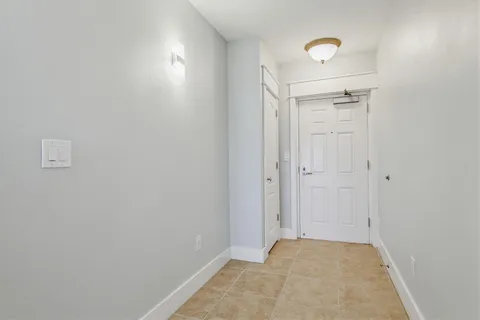 a view of room with window wooden floor and chandelier fan