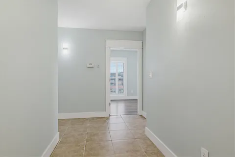 a view of room with a ceiling fan and wooden floor