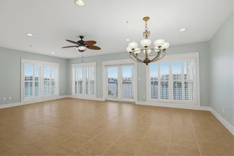 a view of an empty room with a fireplace and a window