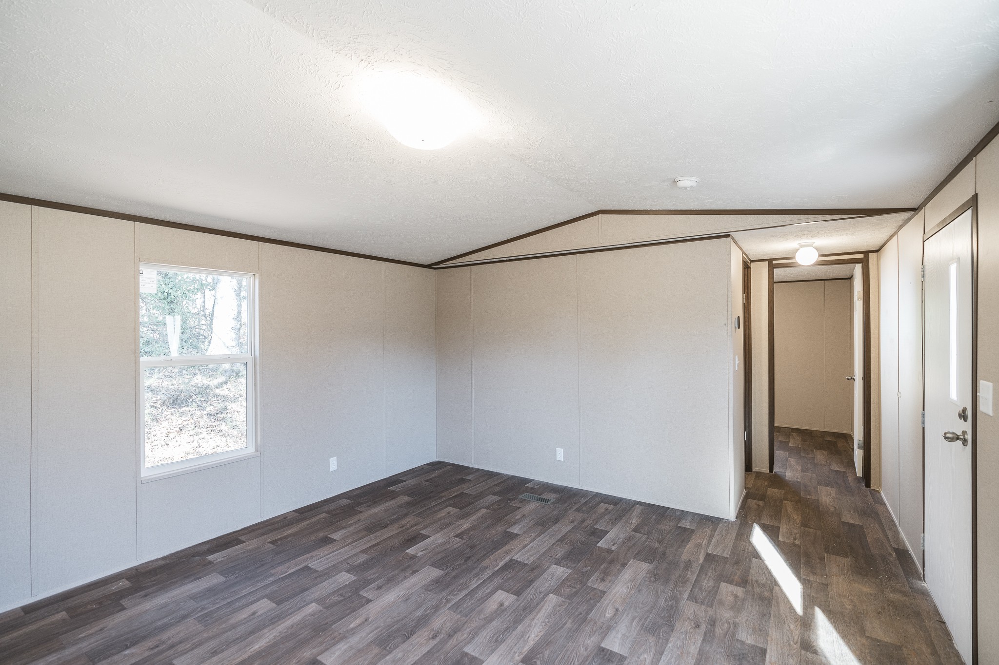 2552 Spring Street Pleasant View, TN 37146 - Photo 6 of 27 a view of an empty room with wooden floor and a window